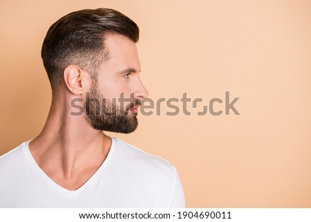 Profile side photo of young handsome bristle man confident look empty space isolated over beige color background Royalty-Free Stock Photo #1904690011