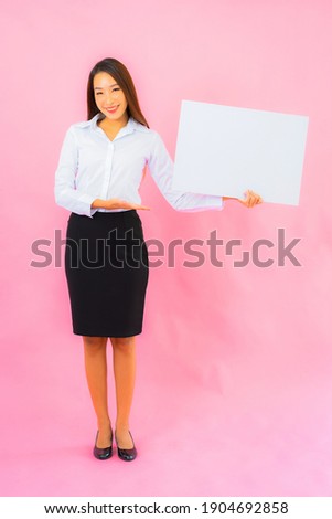 Portrait beautiful young asian woman show empty white billboard on pink color background