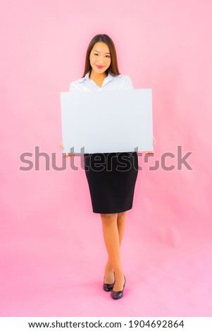 Portrait beautiful young asian woman show empty white billboard on pink color background