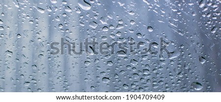Water drops on the window pane. Blurred background, selective focus.