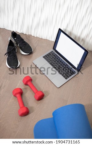 Young sporty slim woman has internet video online fitness training instructor modern laptop screen. Healthy lifestyle concept, online fitness and sport lessons. Exercises at home. Royalty-Free Stock Photo #1904731165
