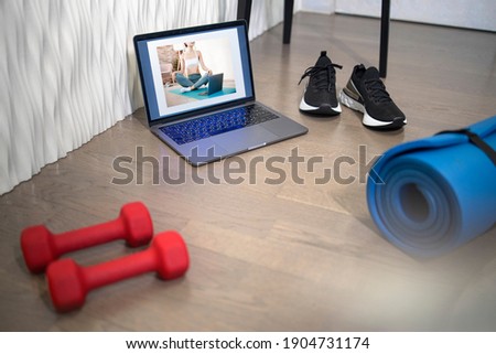 Young sporty slim woman has internet video online fitness training instructor modern laptop screen. Healthy lifestyle concept, online fitness and sport lessons. Exercises at home. Royalty-Free Stock Photo #1904731174