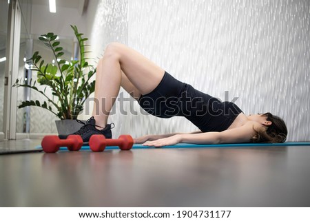 Young sporty slim woman has internet video online fitness training instructor modern laptop screen. Healthy lifestyle concept, online fitness and sport lessons. Exercises at home. Royalty-Free Stock Photo #1904731177