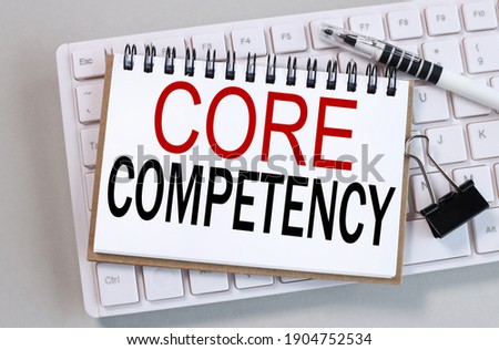 core competency, text on white notepad paper on gray background