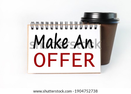 make an offer, text on a notebook on white paper near a cup of coffee