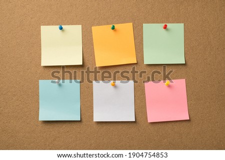 Photo of different colorful memo papers attached with pins to the wooden board Royalty-Free Stock Photo #1904754853
