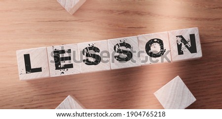 Lessons Word Written In Wooden Cubes. Learning education concept.