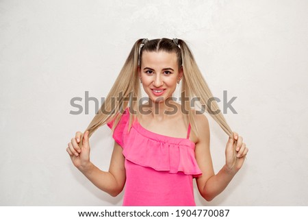 Portrait of a smiling young girl. White background.