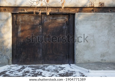Concrete wall with rusty gates. Background with street