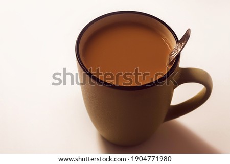 Hot coffee with milk in a mug on a white background