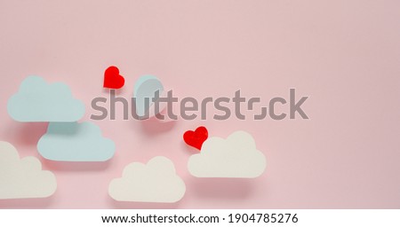 paper cut idea for valentines background, pink and blue paper cut in shape of mini heart and folded like balloon floating in the air and blank space in the left side for edit text,copy space concept. 
