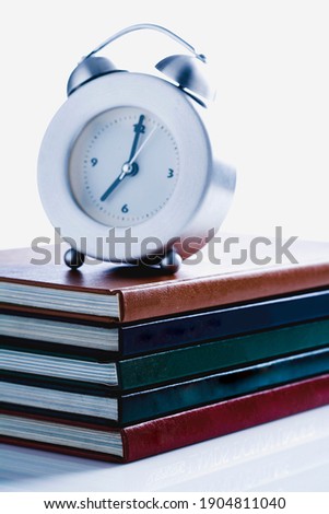 A photo of several books stacked horizontally