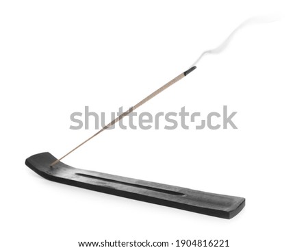 Incense stick smoldering in holder on white background Royalty-Free Stock Photo #1904816221