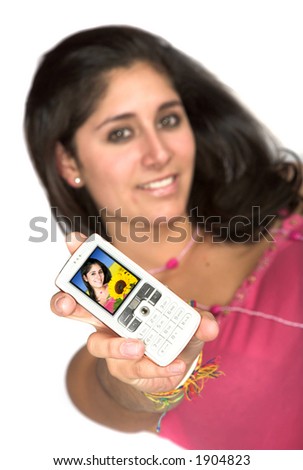 girl in pink holding a cell phone with a nice portrait of her - focus is on the phone - over white background