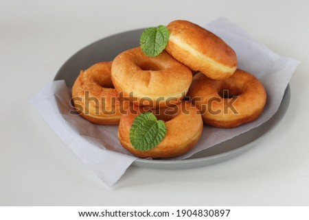 Doughnut or donat kampung is a small industrial version of the donut that shows more local elements. Horizontal close up view.white background