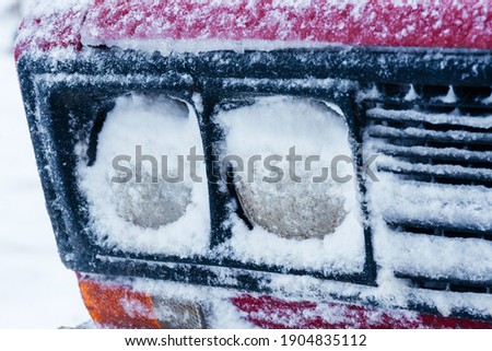 the headlights of the car were covered with snow. Icing of car headlights.