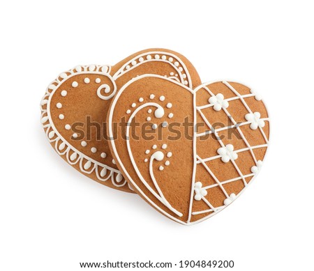 Gingerbread hearts decorated with icing on white background, above view