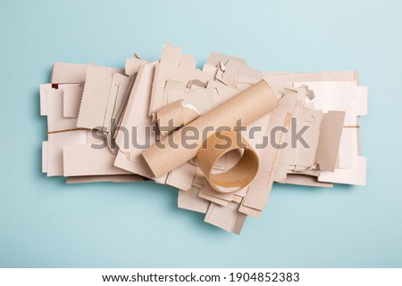 Separate collection of grey cardboard. Paper garbage. Paper stuff for recycle on blue background. Eco friendly concept. Recyclable paper waste on blue. Zero waste. Recycled product, Craft cardboard Royalty-Free Stock Photo #1904852383