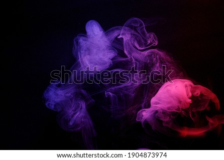 Abstract purple smoke moves on black background. Beautyful swirling smoke.