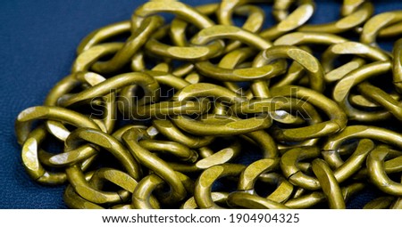 Anodized metal chain, jewelry. The chain is a sequential assembly of connected parts that have a common rope character, since it is flexible and curved.