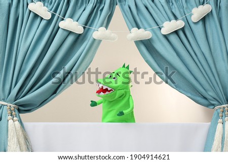 Creative puppet show on white stage indoors Royalty-Free Stock Photo #1904914621