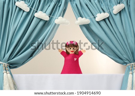 Creative puppet show on white stage indoors Royalty-Free Stock Photo #1904914690
