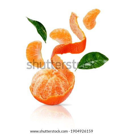 Peeled clementine, sliced mandarine with green leaves flying isolated on white background with clipping path.    Royalty-Free Stock Photo #1904926159