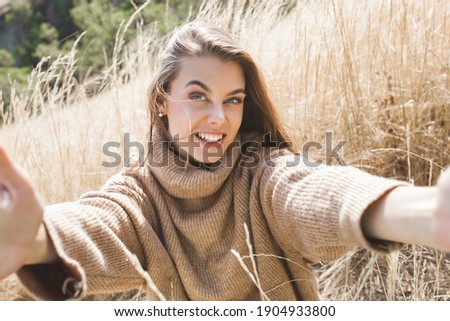 Closeup portrait of young beautiful woman outdoors. Attractive young female on neutral background.