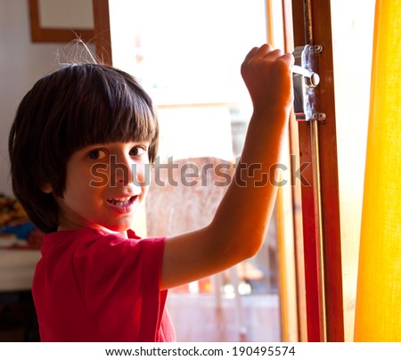 smiling boy opens the door of a new home