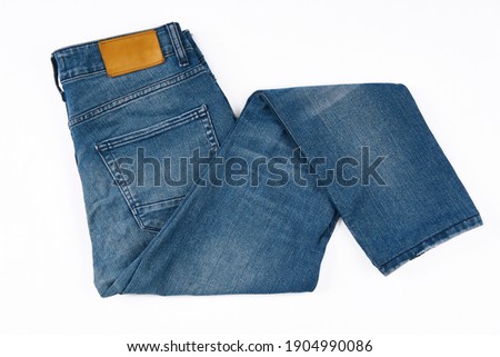 Stack of Various Shades Of Blue Jeans On White Background Denim jeans texture. Denim background texture for design. Canvas denim texture. Blue denim that can be used as background. Royalty-Free Stock Photo #1904990086
