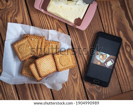 Photo of food taken on the phone by a food blogger, cookies on a wooden tray for a photo on the phone