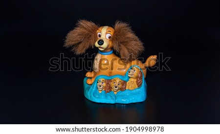 doll dogs Sit on the tray in black background
