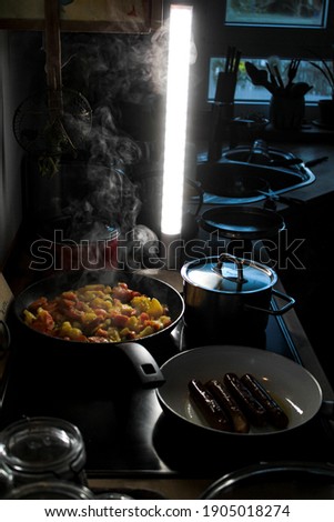 An LED lamp next to a stove while cooking to take photos.