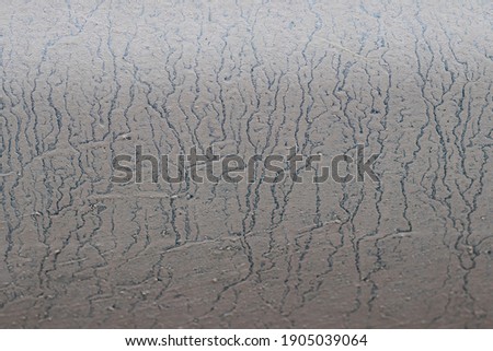 Abstract texture of water blurred dirt on the metal surface of the car