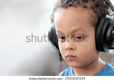 child with headphones enjoying music on white background stock photo  