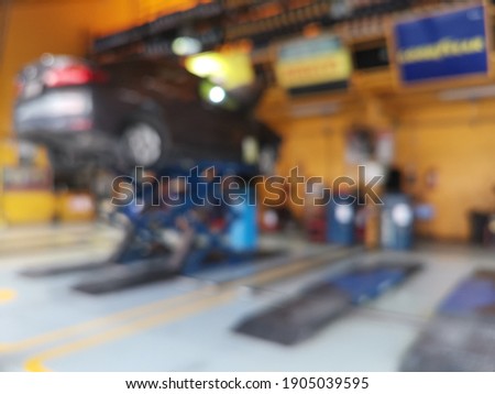 Blur focus of car in maintenance in garage service station, automobile industry