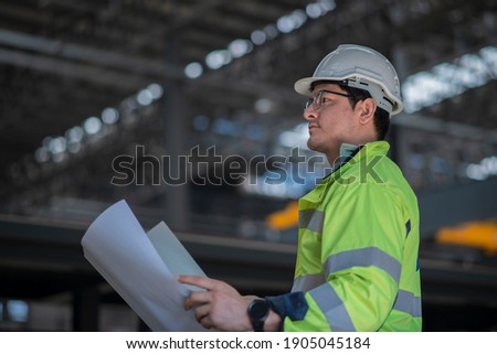 worker work on factory  with hand hold drawing. Heavy Industry Engineer in Pipe Manufacturing Factory, checking job with drawing. Royalty-Free Stock Photo #1905045184