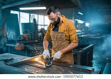 Metal industry worker at factory Royalty-Free Stock Photo #1905077653