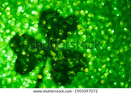 Saint patrick's day shade of clover leaf on green bokeh background.