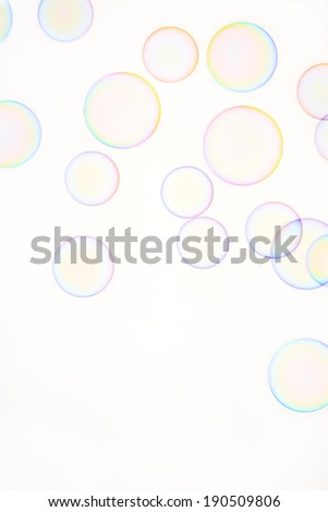 Multicolored soap bubbles against a white background