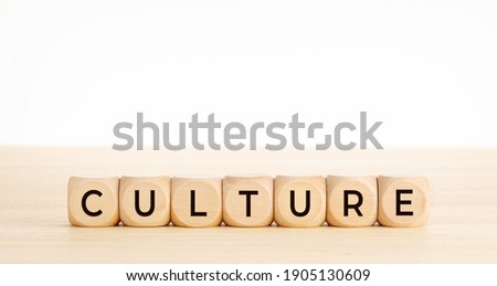 CULTURE word on wooden blocks on wood table. Copy space. White background