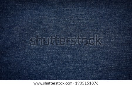 surface of dark navy blue denim jeans fabric for background. Royalty-Free Stock Photo #1905151876