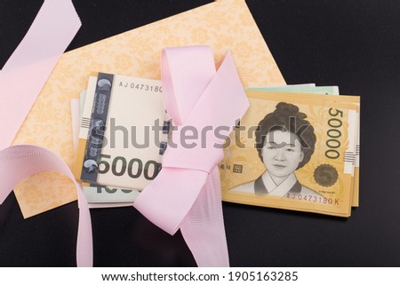 Korea 50,000 won banknote with pink ribbon