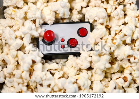 Close-up of video game controller and popcorn. Afternoon of video games and popcorn, evening with friends.