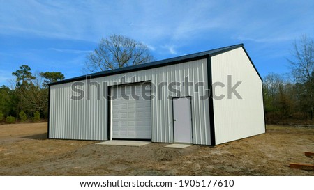 Post frame storage shed perfect for lawnmowers, trailers, ATV's, vehicles, boats, any recreational activities Royalty-Free Stock Photo #1905177610