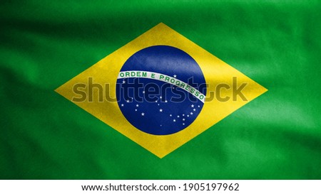 Brazilian flag waving in the wind. Close up of Brazil banner blowing, soft and smooth silk. Cloth fabric texture ensign background. Use it for national day and country occasions concept. Royalty-Free Stock Photo #1905197962