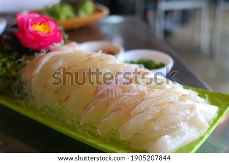 It is a raw fish dish with fresh halibut meat sliced and served with a vinegar gochu-jang dipping sauce.
