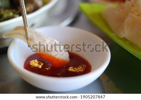 It is a raw fish dish with fresh halibut meat sliced and served with a vinegar gochu-jang dipping sauce.