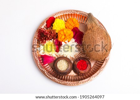 Beautifully Decorated Pooja Thali for festival celebration to worship, rice grain and kumkum, flowers, hindu puja thali. Royalty-Free Stock Photo #1905264097