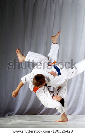 In judogi two athletes doing judo throws Royalty-Free Stock Photo #190526420